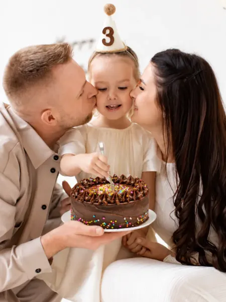 Familia celebrando el cumpleaños de su hija con una torta